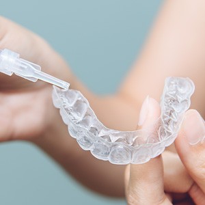 Teeth whitening gel being applied to a clear tray